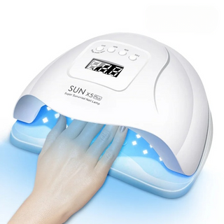 Lampe uv ongles à LED pour vernis à gel avec la main d'une femme à l'intérieur sur fond blanc